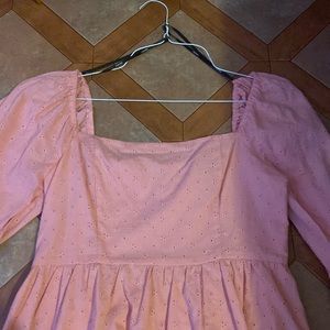 A knee length pink midi dress